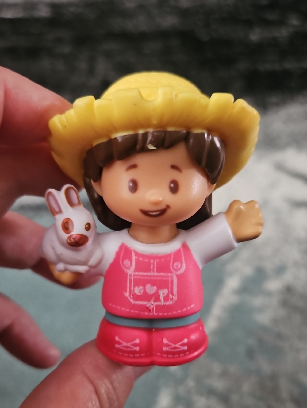 Fisher-Price Little People Farmer Mia figure holding a bunny